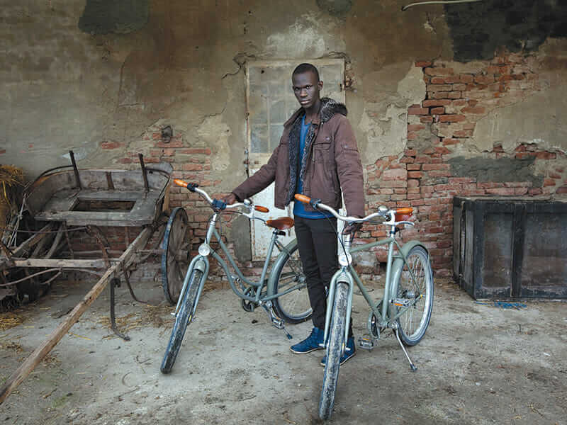 Omar Fall, 19, native of Senegal, is responsible for the maintenance of the handmade Abici bicycles available to guests.