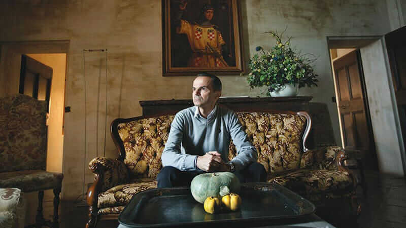 Luciano Spigaroli, co-owner of the Antica Corte Pallavicina, photographed in one of the castle's communal living rooms.