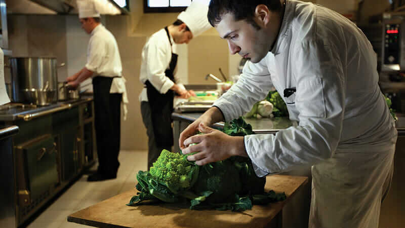 In the kitchen of the restaurant, chef Angelo Durante selects seasonal vegetables grown in the garden