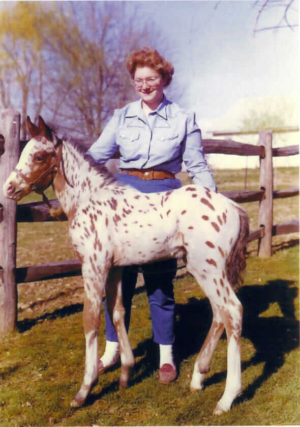 A young Fox with one of her Appaloosa ponies.