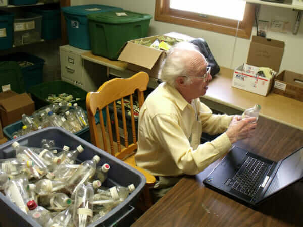 Richard Simon Hanson, volunteer at Seed Savers Exchange, inventories some of Fox's beans.