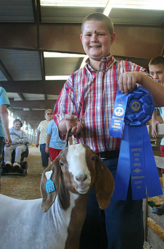 Shelvin Arey, 12, and his goat, Fuzz, celebrate a first-place finish in a heat of the mediumweight class.