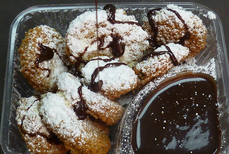 Preferred Pickles' popular deep fried pickles dusted with powdered sugar and served with a side of chocolate for dipping.