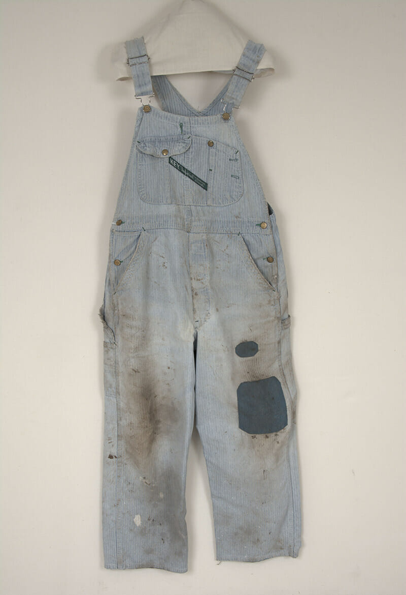 Overalls worn by Kansas farmer Dale 'Pete' McKale, on display in the Kansas Museum of History.