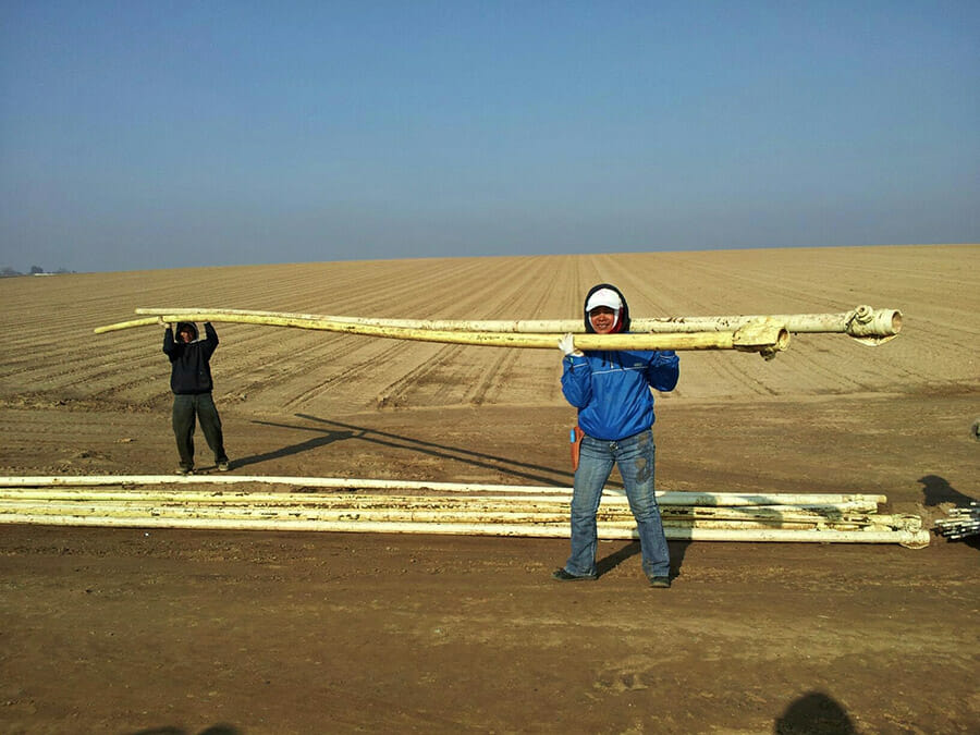 Carrying irrigation pipe lines near Hickman Ca. 2011.