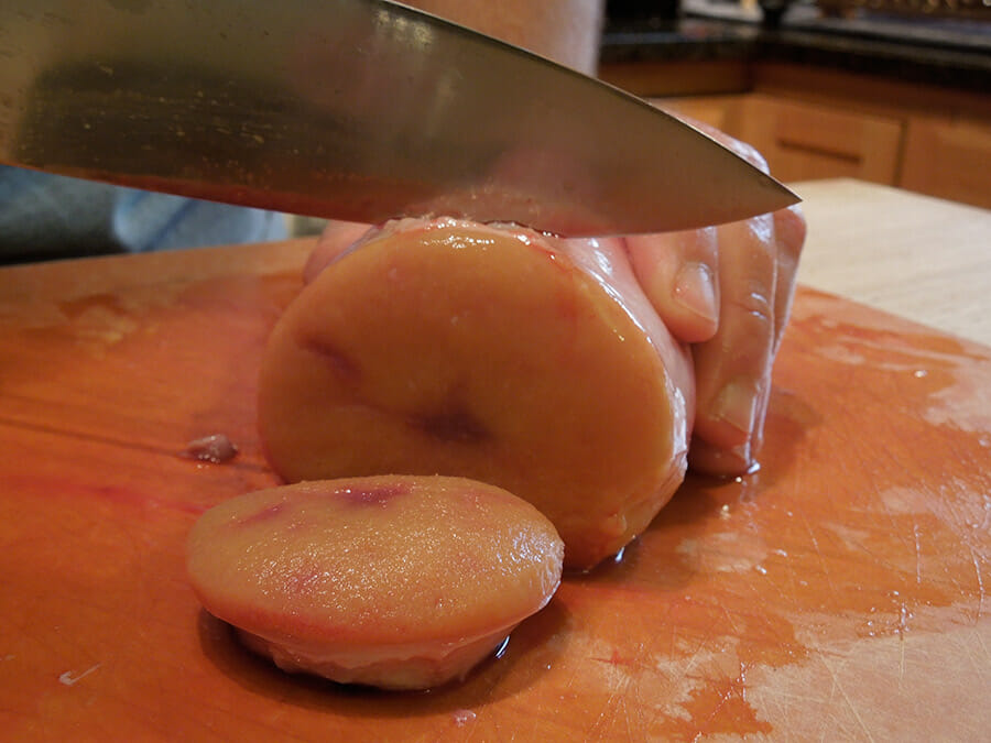 Slicing the testicles in preparation for frying.