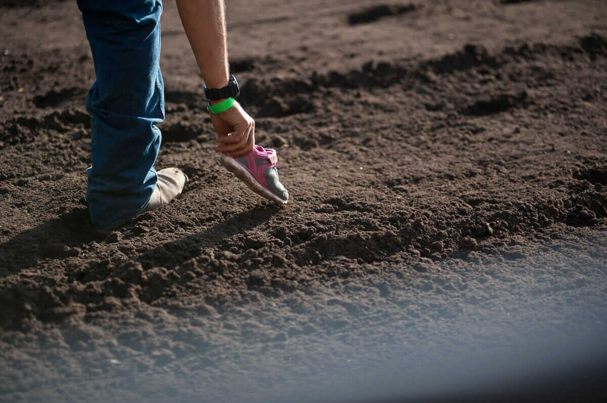 A Tommy G. Productions employee picks up a lost shoe after a competitors ride.