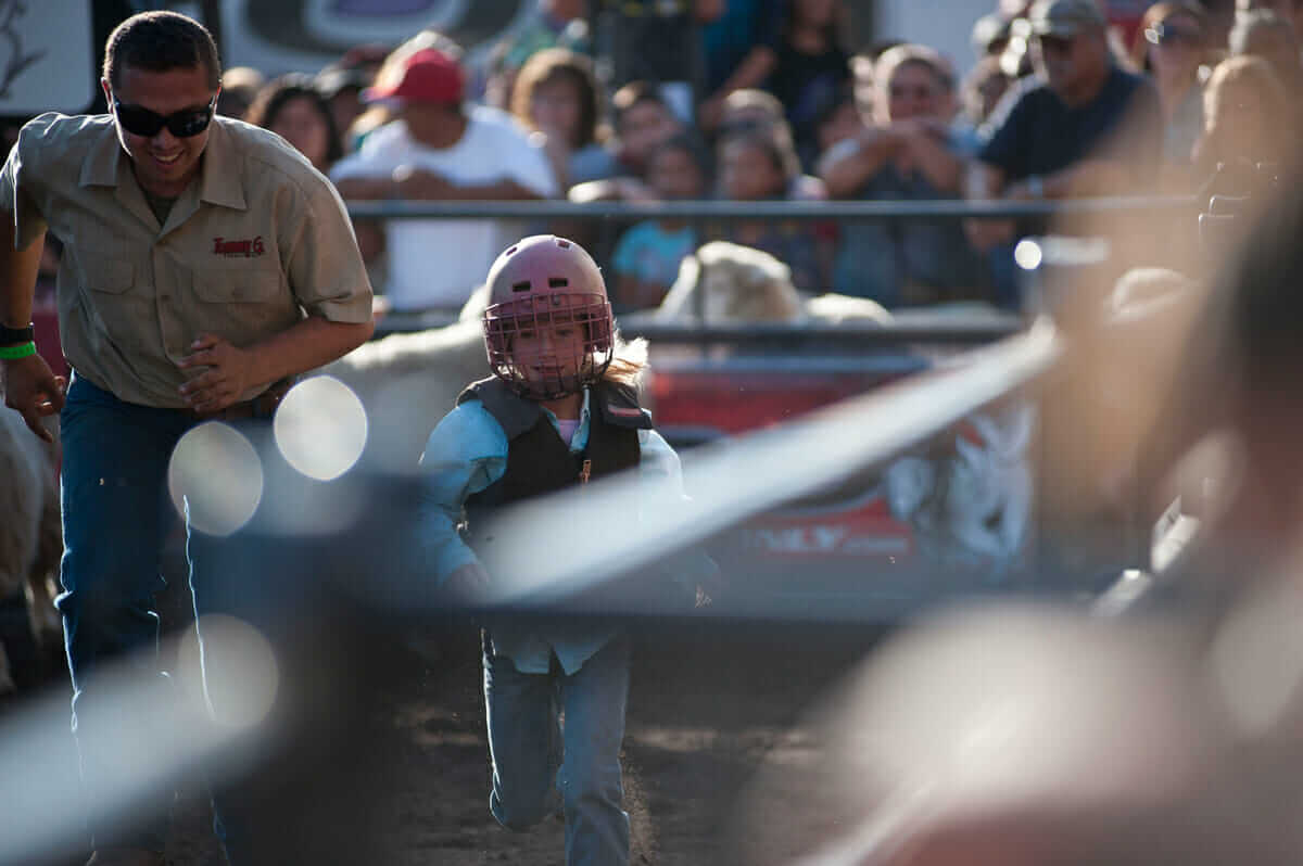 Zoe races back to the starting gate after she is granted a rerun. A second run is allowed if the sheep stops running before it reaches the end of the corral. 