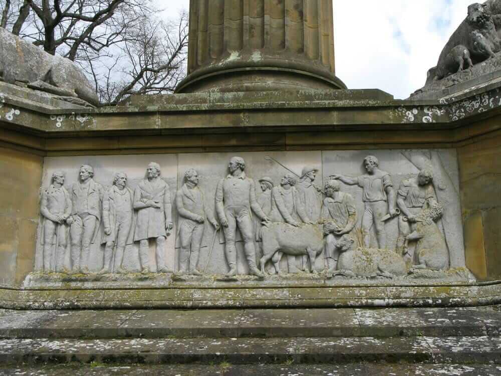 A detail of the Coke Monument at Holkham Hall, featuring sheep and their masters. / Courtesy Holkham Estate