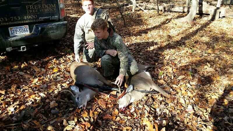 Posing with a recently killed deer are Howard Curtis' son (back) and nephew (front). Photo courtesy Howard Curtis.