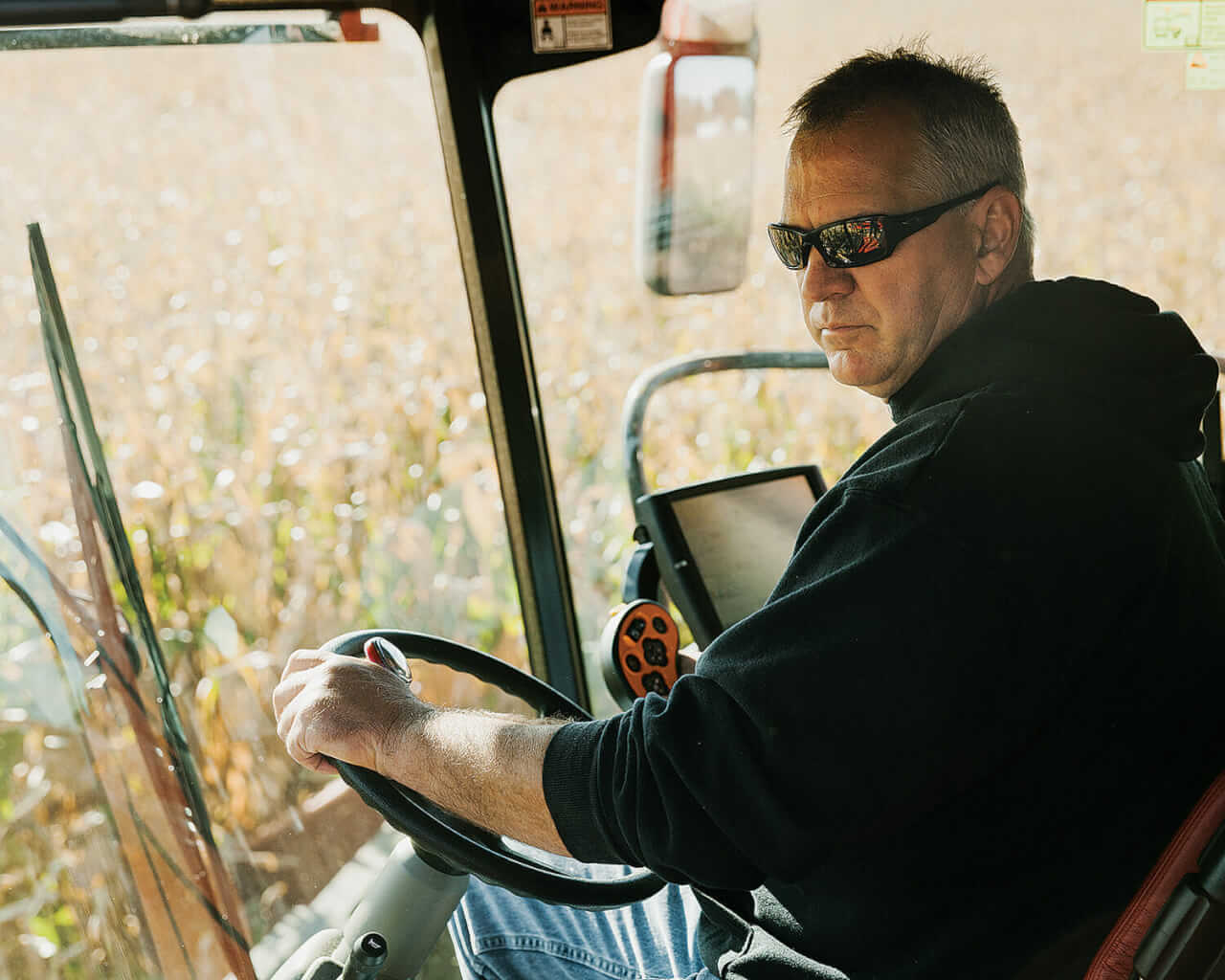 Huegerich, in his combine. He has no ideological problem with GMOs but has been experimenting with conventional seeds for financial reasons