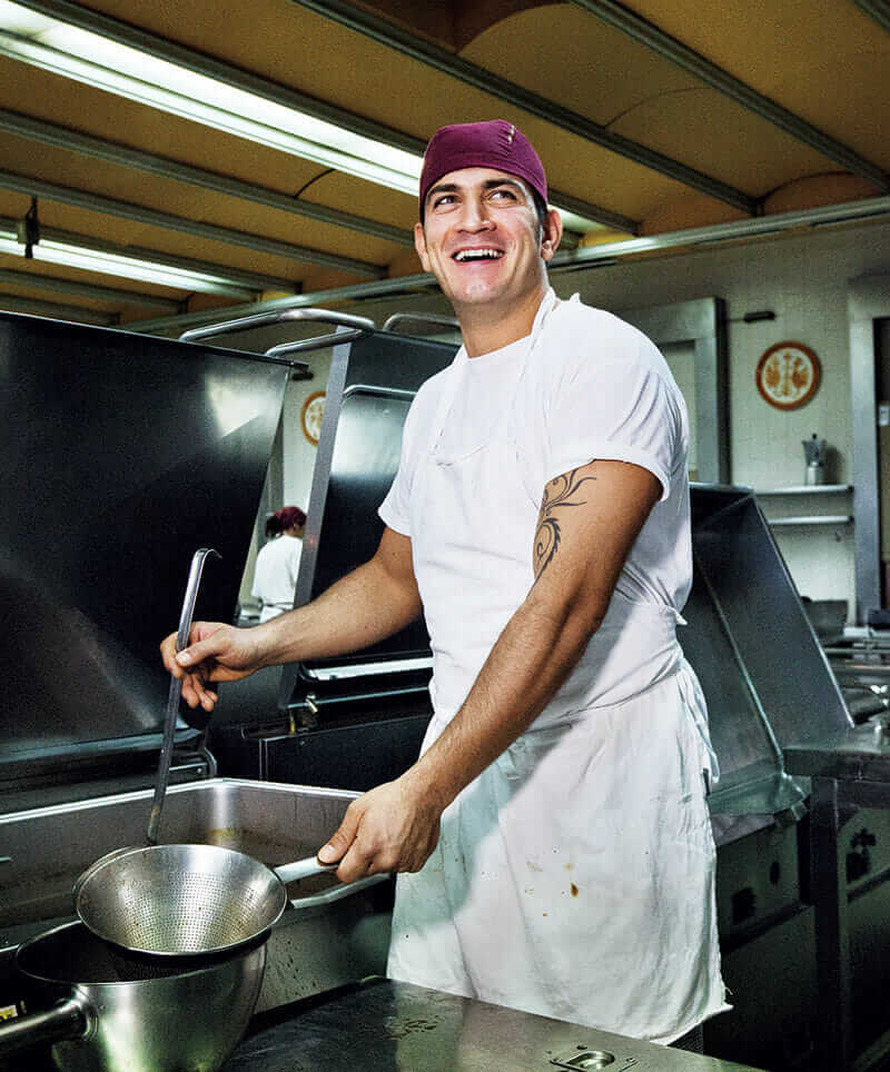 A resident works in San Patrignano's kitchen, where thousands of meals are served every day.