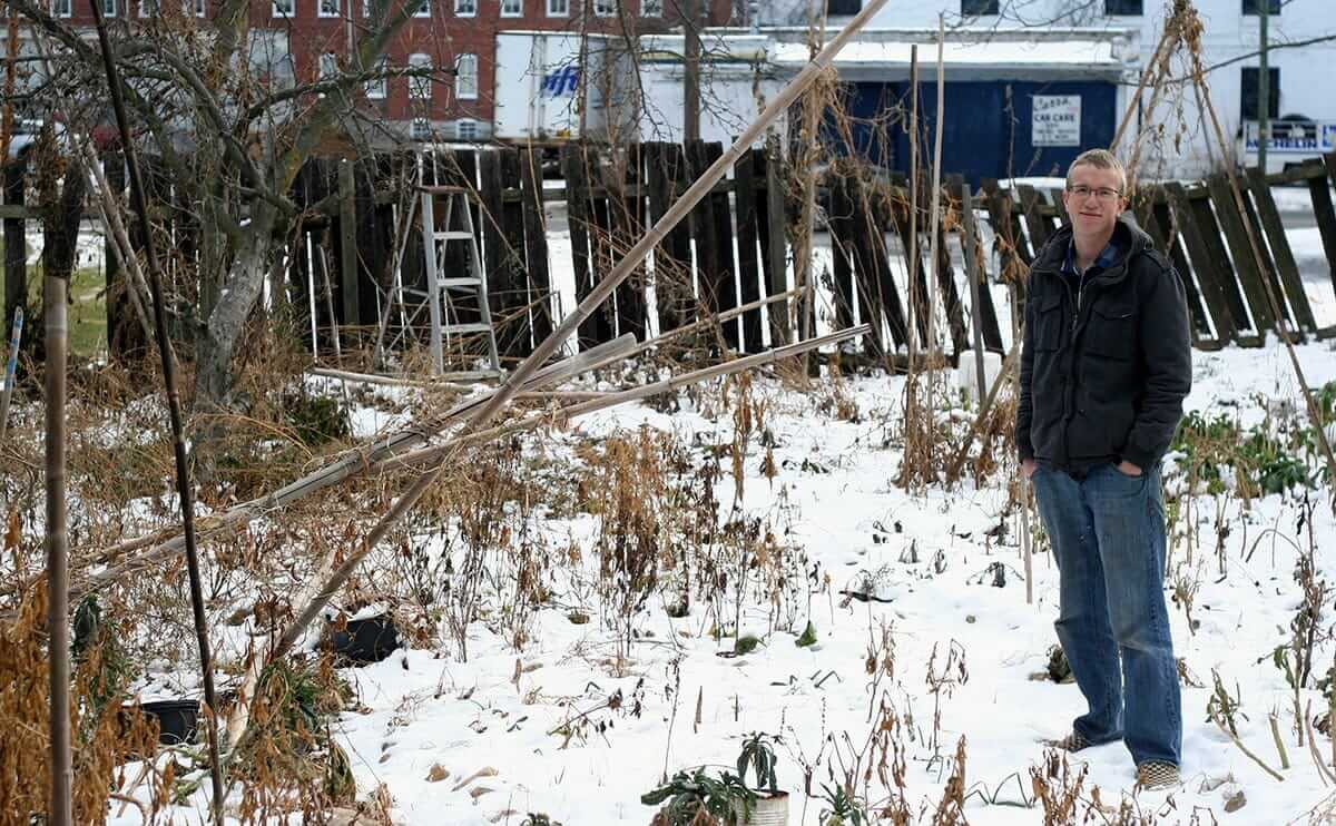 Dan Warren standing among the remains of his urban farm in December 2013, after the business had run its course and his partner, Sam, has already left town.