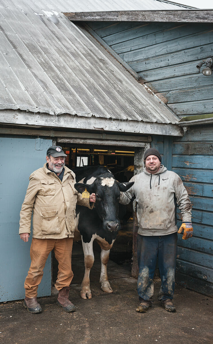 Ronny and his son, Dan, stand outside the milking parlor with a particularly docile cow. Ronny, the farm's namesake, still runs operations. Dan can usually be found closer to the ground, kneeling and milking the cows. Still, Ronny is no slouch: He spends his days roaming the grounds, supervising all the moving parts of the farm that he founded.
