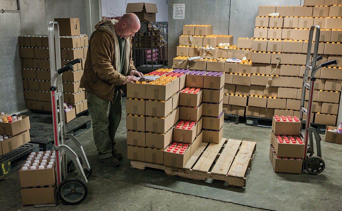 A driver checking out one of his drinkable yogurt orders. In the winter, when it's cold, the drivers fulfill their orders themselves in the warehouse.