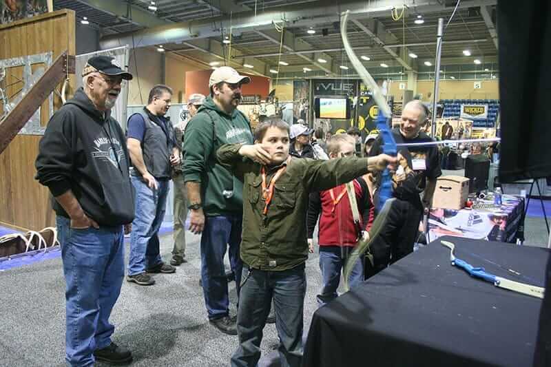 A beginning archer takes aim at the Great American Outdoor Show.