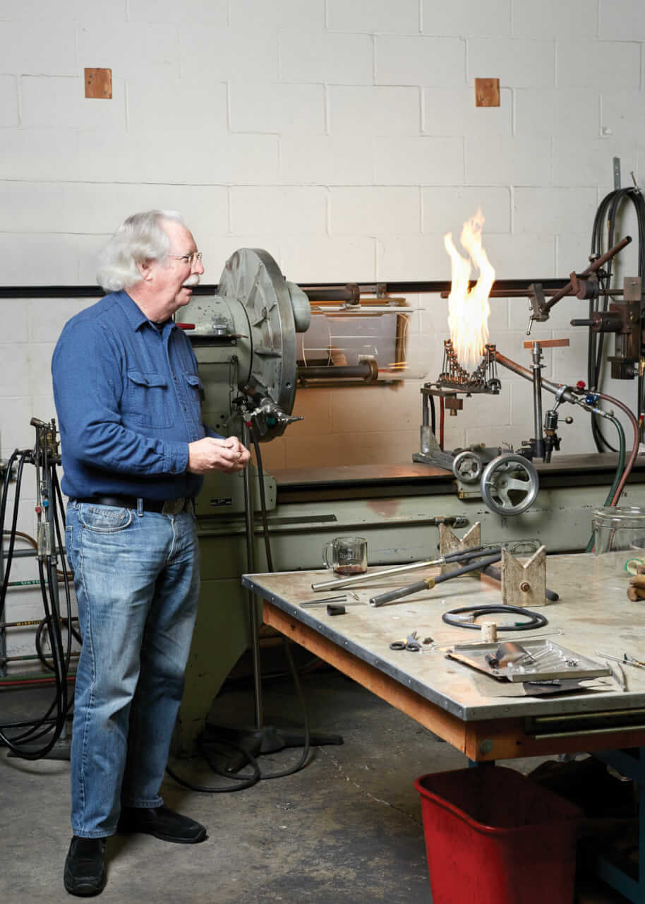 

Tom Adams with a glassblowing lathe and crossfire.

