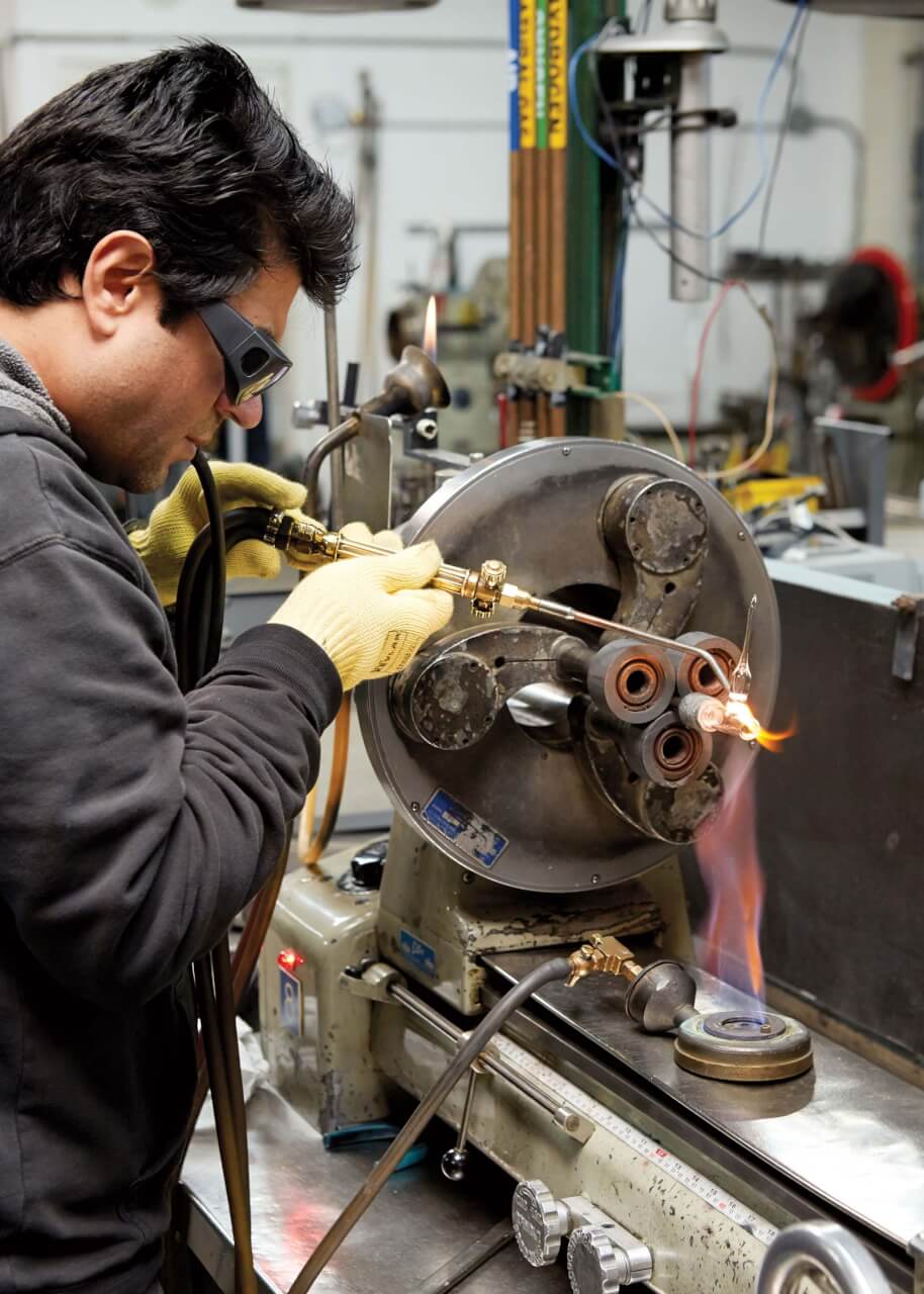 Ali Kamburov works on an apparatus called an H-Cell, used for electrochemistry.