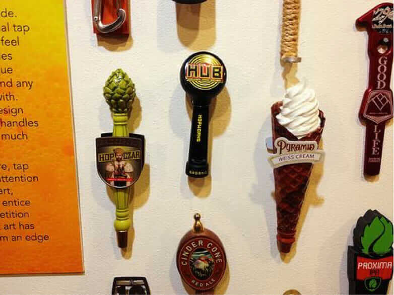 A wide collection of bottles and tap handles in Springfield, Oregon's exhibition, 'Behind the Label: The Art of Oregon's Craft Brewers.' Courtesy of Oregon Hops and Brewing Archives.