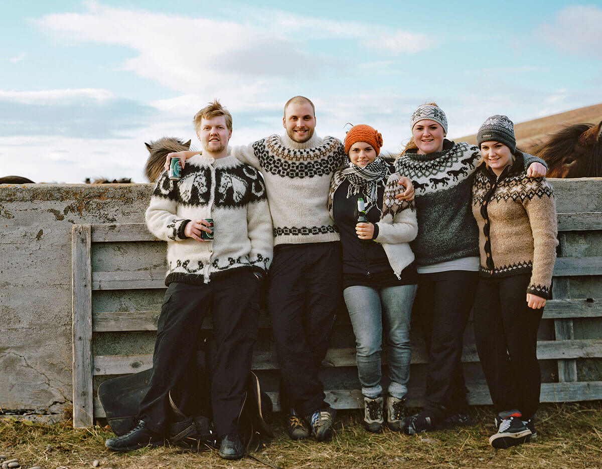 A group of young Icelanders wear hand-knit wool sweaters at the LaufskÁ¡larétt sorting pen in northern Iceland.