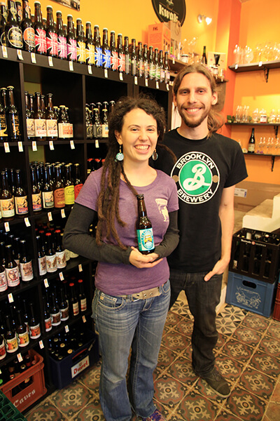 Pierre and Jaclyn Gidel with a bottle of La Levalloise in their shop, Biérocratie. / Courtesy Clément Leriche