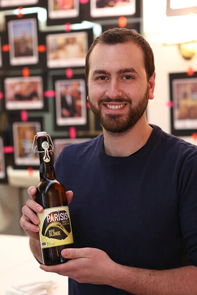 Brasserie Parisis founder Jonathan Abergel poses with his 'blonde' beer. / Courtesy Cervia Ile de France