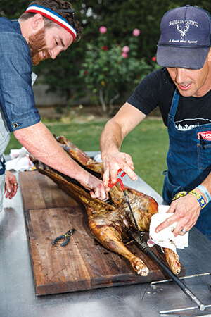 Chef Christian Page of Short Order (left) and his sous chef preparing lamb.