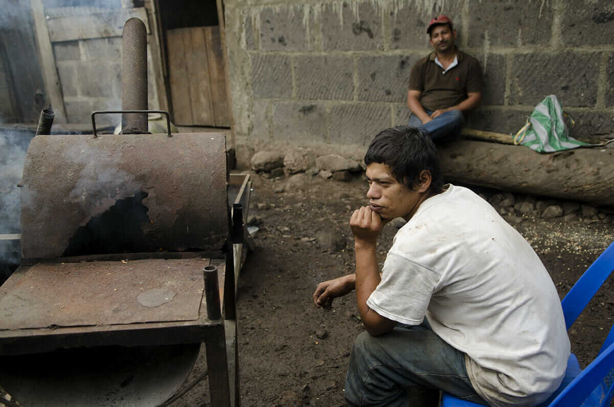 Marvin Pérez waits for his coffee to roast with the local roaster.