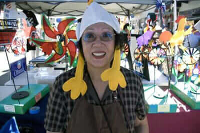 A woman at the 2009 fair gets into the spirit of things with a chicken hat.