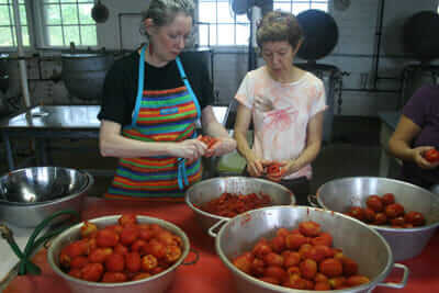 Fonda Nichols (left) and Lise Metzger, friends from Falls Church, Va., drove two hours to can 75 pounds of tomatoes at the Keezletown Community Cannery ”“ one of the last remaining public canneries opened during the World War II Victory Garden era.