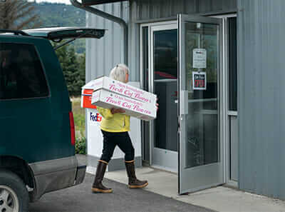 Beth VanSandt takes her daily flower shipment to the local FedEx facility near Homer Airport.