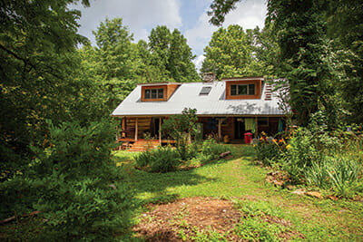Students gather at Katz's solar-powered log cabin in rural Tennessee.