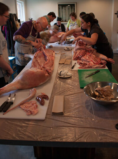 In a Spring course at the Seattle Meat Collective, students are working with the carcass of a full hog.