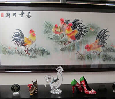 The room contains rooster statues, sriracha high heels and everything else rooster.