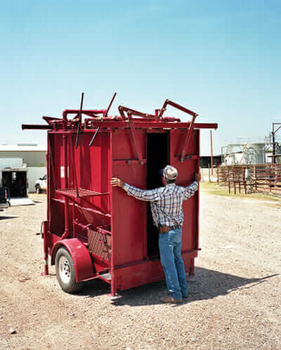 Bill Coble, Webb County Tick Supervisor, opens a portable spray-dip machine used for treating cattle with a tickicide.