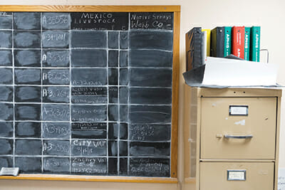 At the Webb County administrative office, livestock records are recorded on a chalkboard.