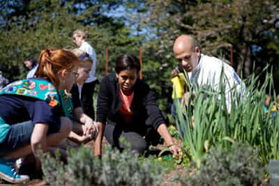 Sam Kass and Michelle Obama plant on the South Grounds with Girl Scout Troop 60325. / Courtesy the White House.