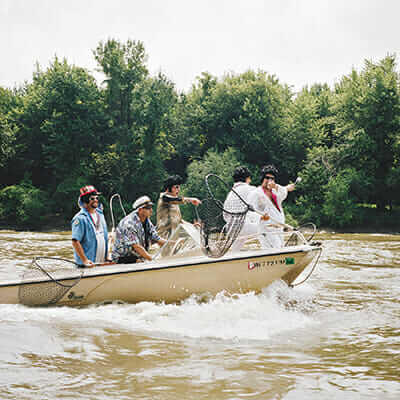 A group of fishermen ride out to get a spot on the river.