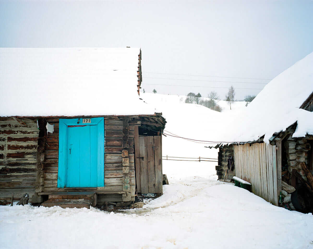 These modest, wooden homes are typical for the region. Blue paint is very popular in the village, partly because it is the cheapest option, but also because the villagers favor bright colors.