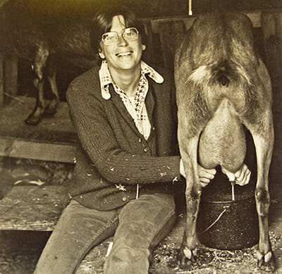Sherry Thomas, one of the original Country Women Magazine founders, milks a goat on Black Sheep Farm ca. 1970. / Courtesy Lynda Koolish.