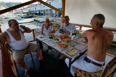 Black Sea fishermen drink raki and eat lunch at a fishing port just outside of Rize.