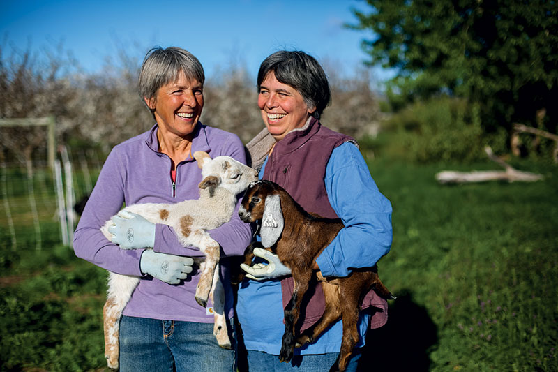 two women and goat