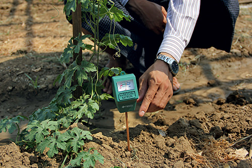 Proximity Designs works directly with farmers in Myanmar to field-test prototypes for new devices, like this moisture sensor, which indicates when fields need watering.