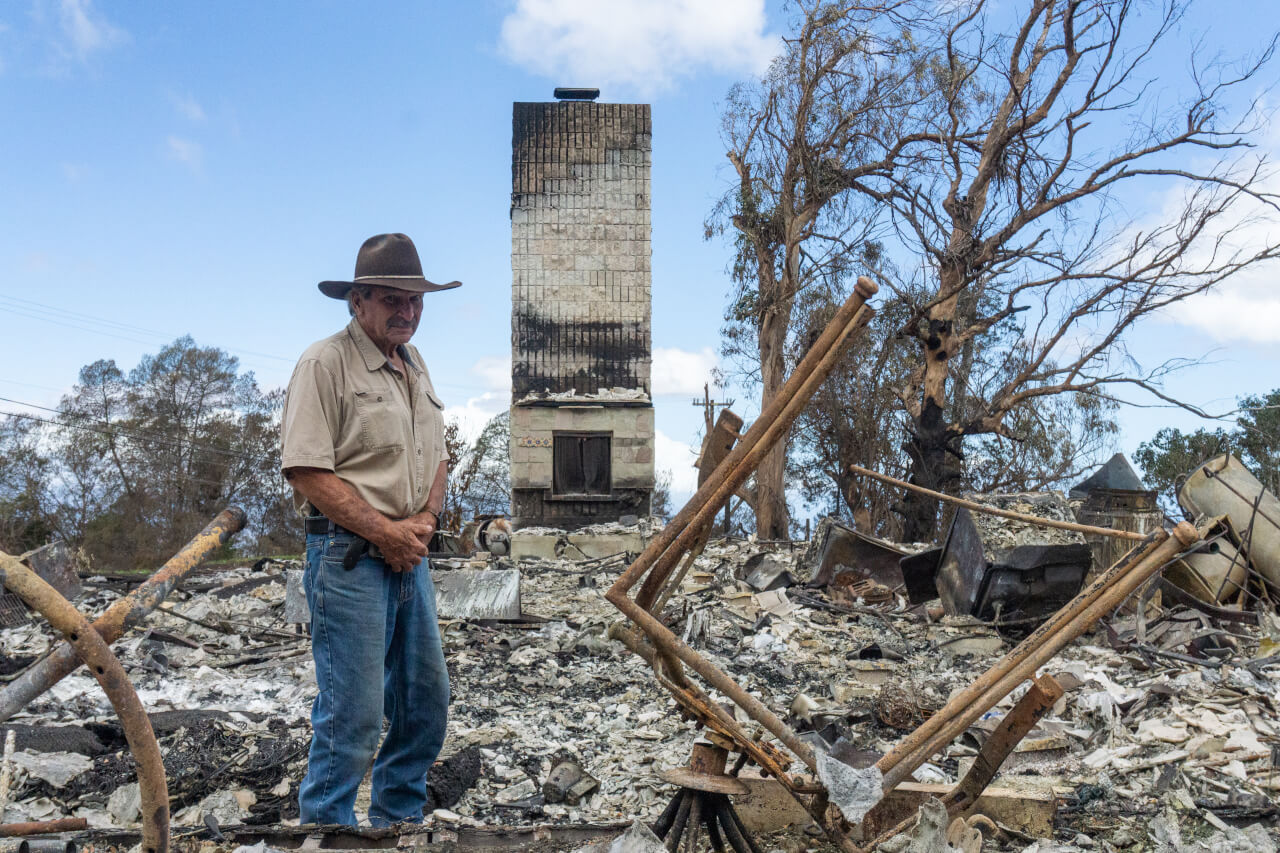 Wagner stands in front of his burned home