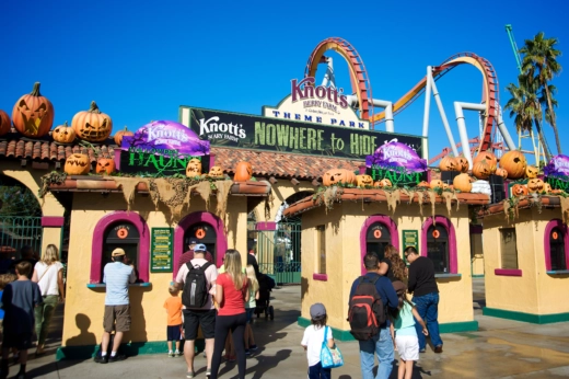 People gather at the entrance to a theme park.