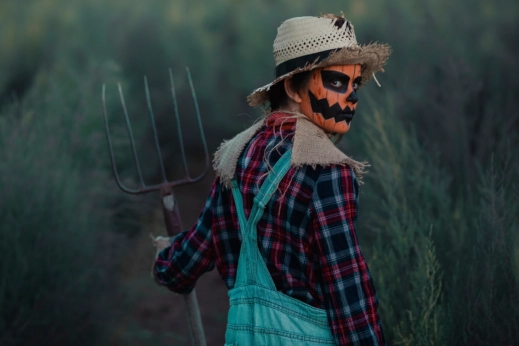 A person with a pitchfork looks over their shoulder.