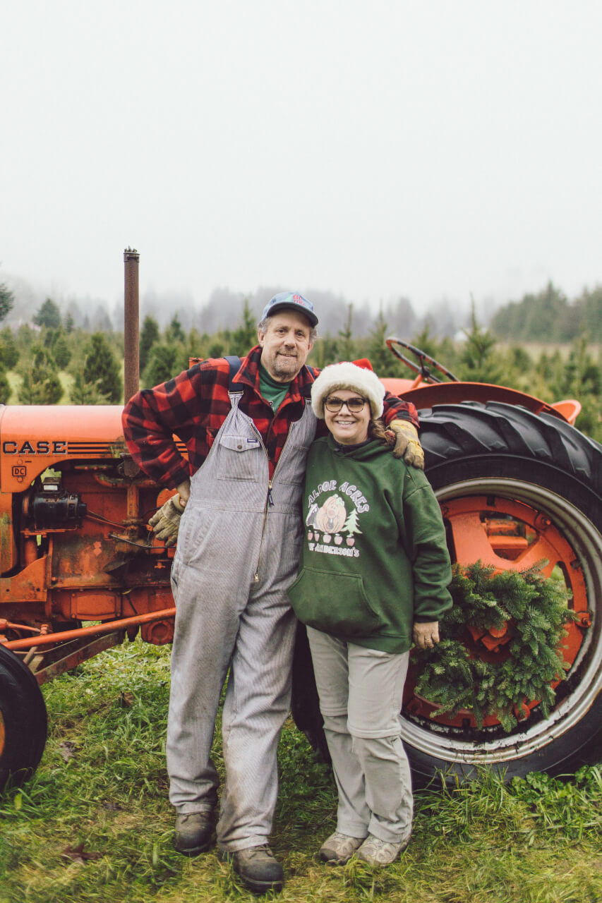 Two people in front of a tractor