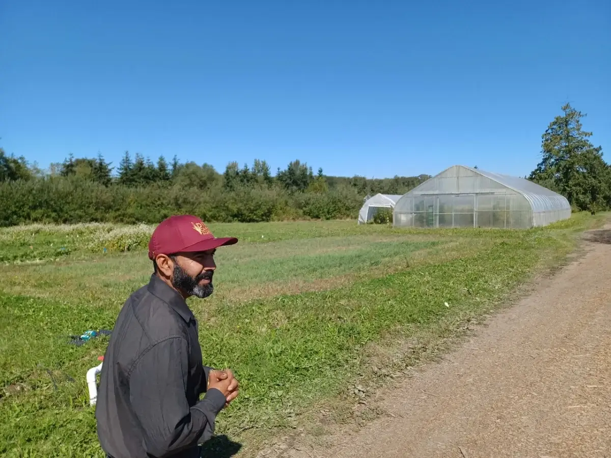 Francisco Farias stands in a field at Viva Farms.