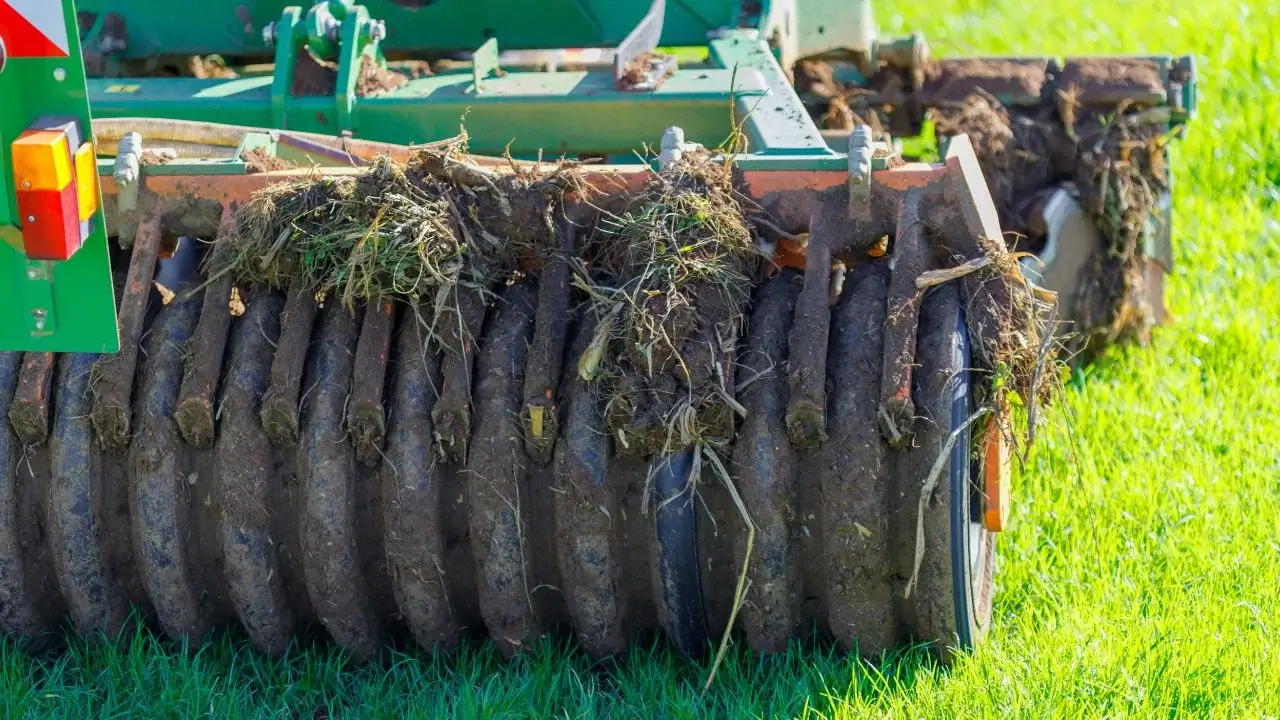 A machine for roller crimping grass, appearing to have blade-like rollers that break apart soil and grass