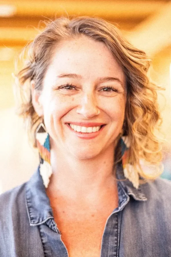 A photo of Brandy Hall, taken somewhere with warm sunlight with a wooden ceiling visible in the background